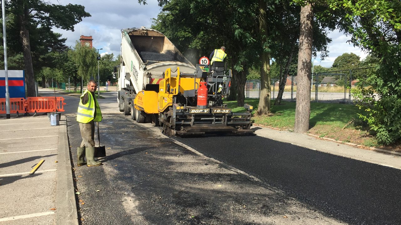 Atkinson Surfacing crew machine-laying fresh asphalt