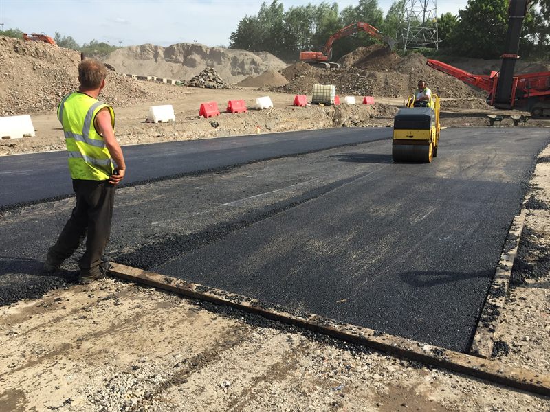 Roller compacting newly laid asphalt on a commercial surfacing project