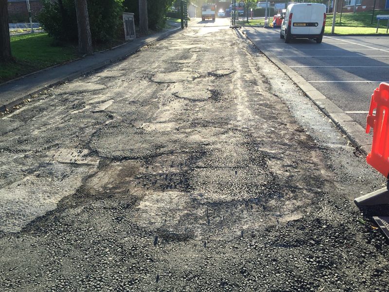 Worn and patched roadway before resurfacing