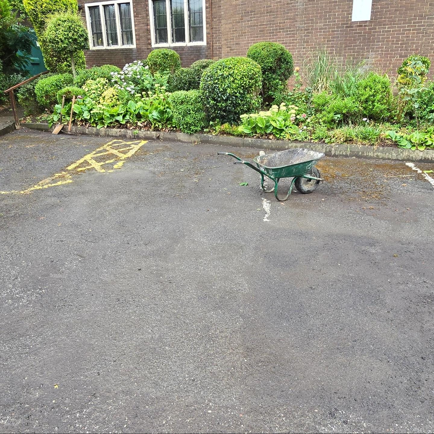 Worn St Urban's Church car park surface with faded yellow and white markings before resurfacing