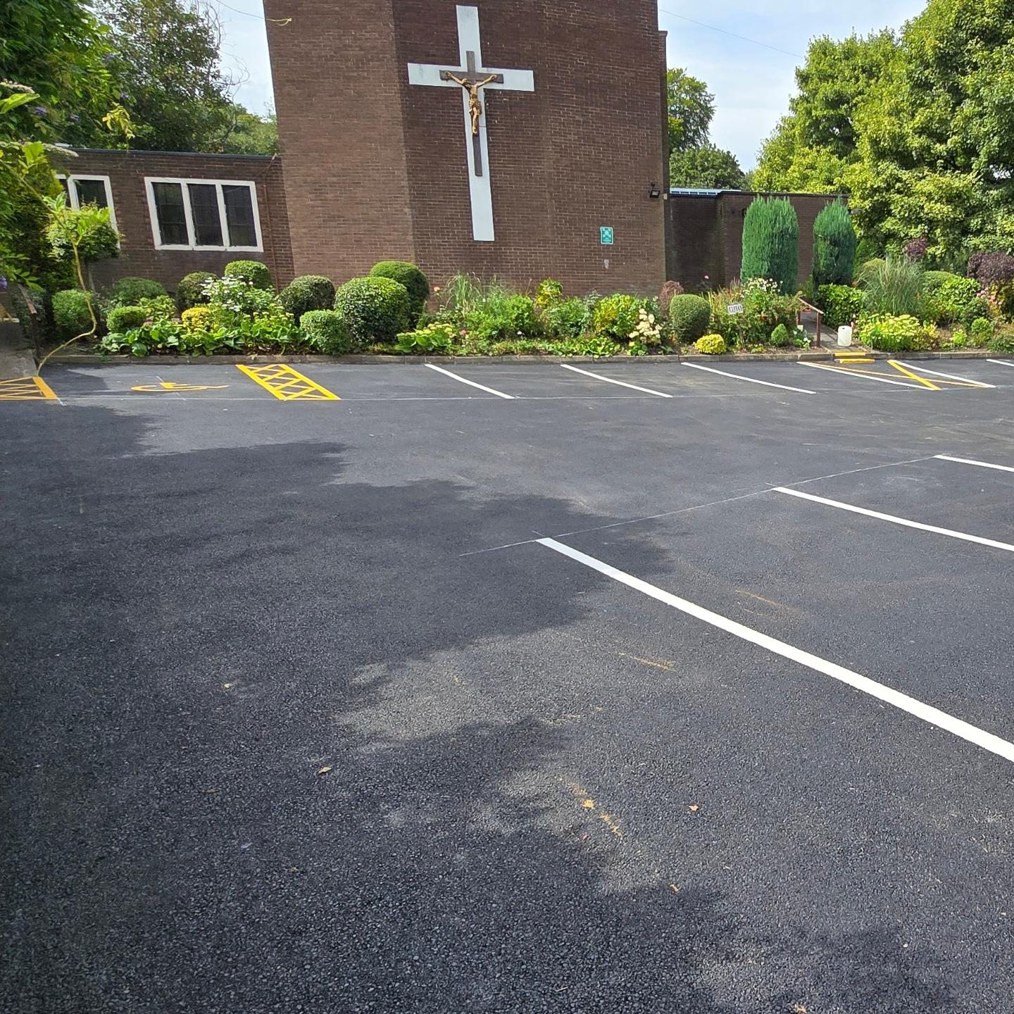 Completed St Urban's Church car park with new white bay markings and yellow accessibility markings